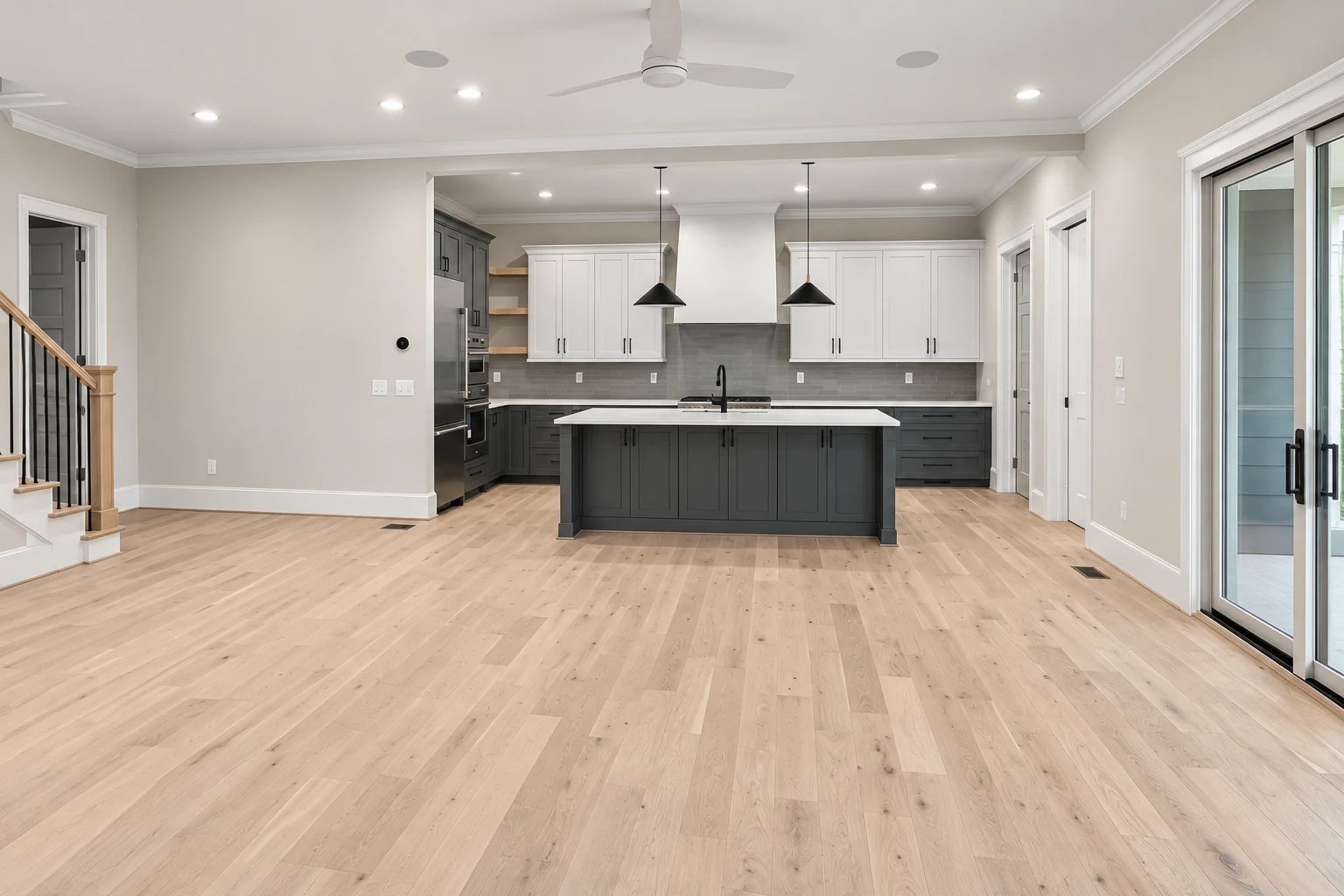 Light oak flooring, staircase and charcoal cabinetry in a complete-room visualization