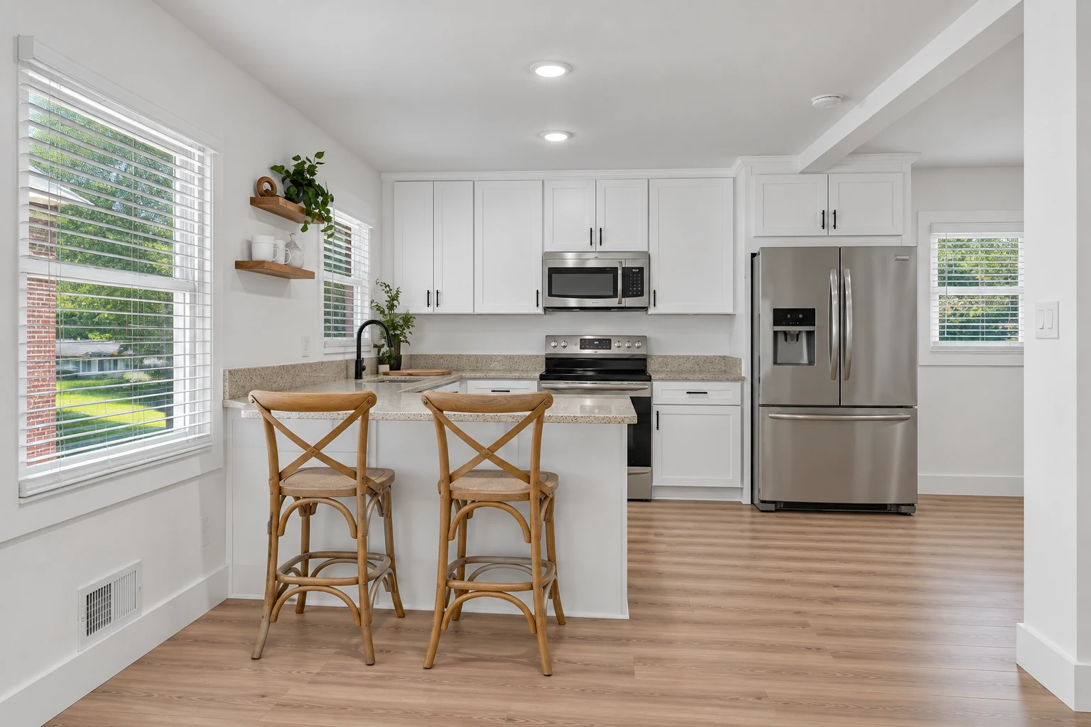 White shaker kitchen with light wood flooring and dark hardware, completed with AI from a Paragon project photograph